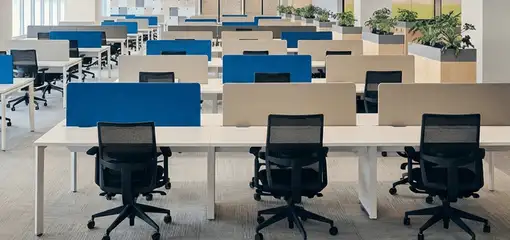Modern open-plan office space featuring clean workstations, ergonomic chairs, and sanitized carpets provided by professional office cleaning services in Saint Louis, MO.